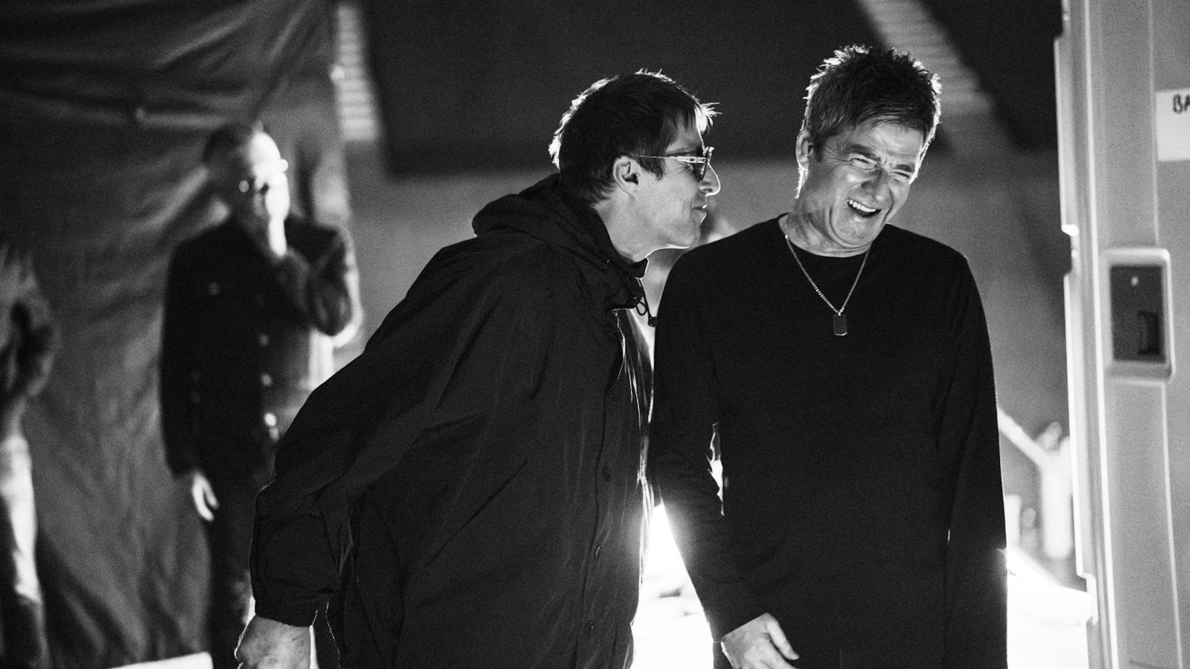 Turne sırasında kuliste Liam Gallagher ve kahkaha atan Noel Gallagher