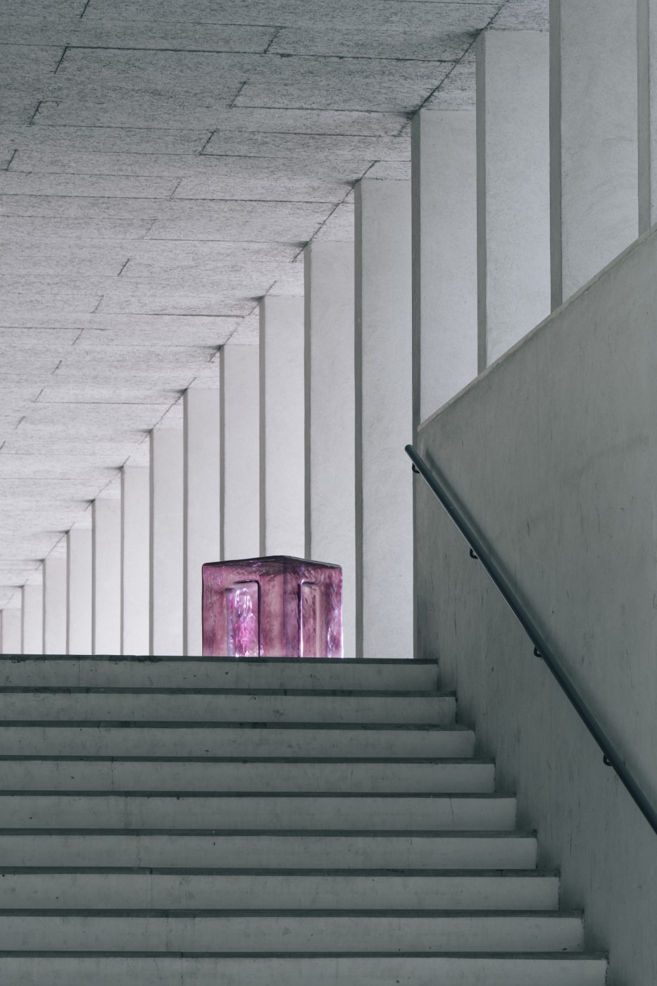 Beton merdivenin tepesinde mor cam küp