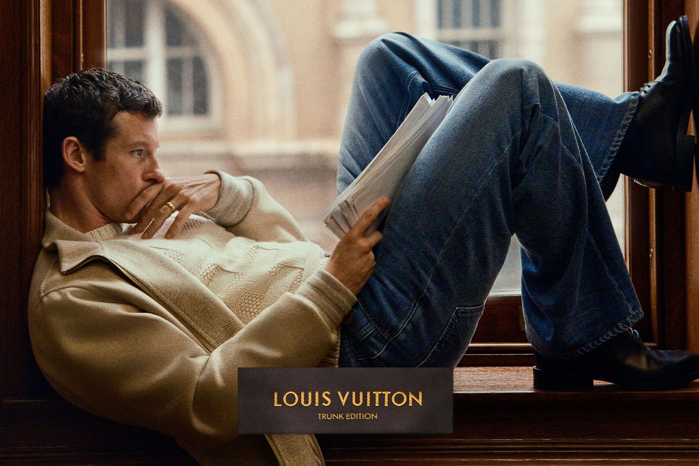 Callum Turner Louis Vuitton kampanyasında pencere önünde gazete okurken